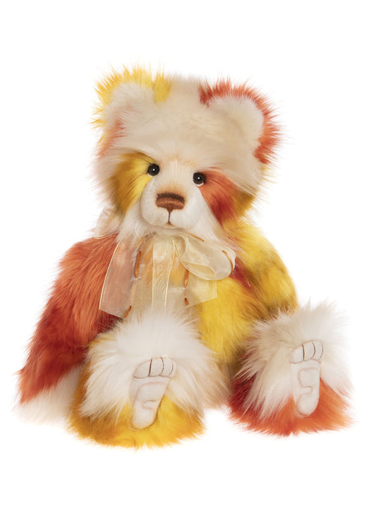 Yellow, orange, and cream colored Charlie Bear panda with light bow